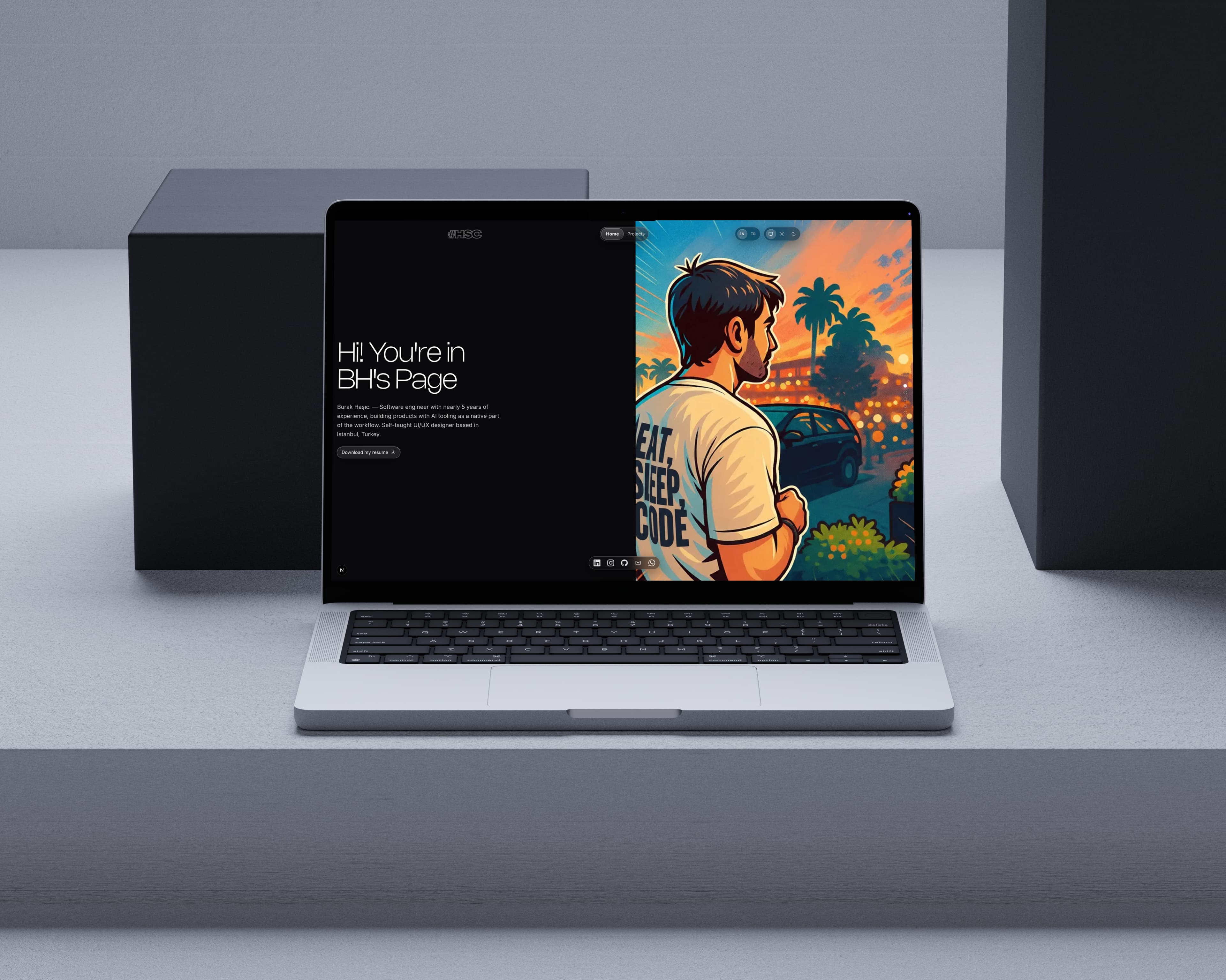 The portfolio home page in dark theme, displayed on a laptop standing on a pale grey studio set